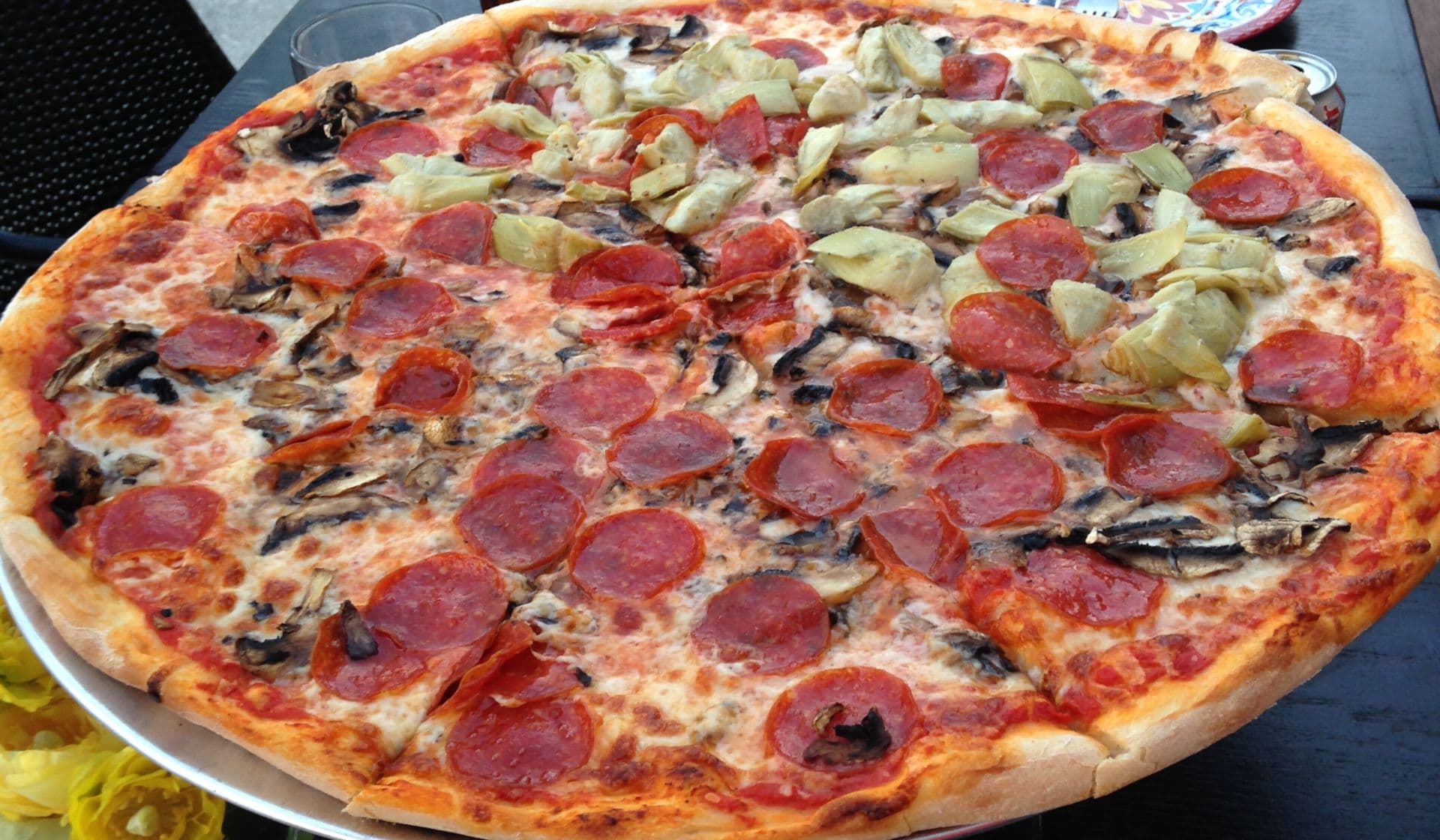 A 20 inch hand-tossed pizza, fresh from the wood-fired oven at Trattoria Da Mino